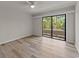 Bright bedroom with hardwood floors and glass door access to the balcony at 415 Ocean Creek Dr. # 2388, Myrtle Beach, SC 29572