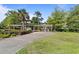 Inviting walkway through a garden with a pergola leading to the building entrance at 415 Ocean Creek Dr. # 2388, Myrtle Beach, SC 29572