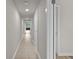 Hallway with tile flooring, neutral paint and doors along each side at 415 Ocean Creek Dr. # 2388, Myrtle Beach, SC 29572