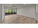 Bright living room with hardwood floors and a large glass door with access to the balcony at 415 Ocean Creek Dr. # 2388, Myrtle Beach, SC 29572