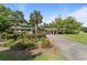 Inviting walkway through a garden with a pergola leading to the building entrance at 415 Ocean Creek Dr. # 2388, Myrtle Beach, SC 29572