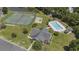 An aerial view shows tennis courts, swimming pool, and clubhouse surrounded by lush greenery and landscaping at 4280 Santolina Way # C, Murrells Inlet, SC 29576