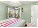 Inviting bedroom featuring a large window, sliding door closet, and neutral decor at 4280 Santolina Way # C, Murrells Inlet, SC 29576