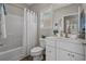 A bright bathroom featuring white cabinets and a combined shower and tub area at 4319 Grande Harbour Blvd., Little River, SC 29566