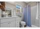 Cozy bathroom with a combination shower and tub, window, vanity with storage, and neutral paint at 4319 Grande Harbour Blvd., Little River, SC 29566