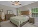 Bedroom featuring neutral decor, ample natural light, ceiling fan, and wooden furniture at 4319 Grande Harbour Blvd., Little River, SC 29566