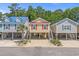 Three cute coastal homes, elevated construction, lined up on a picturesque street, perfect for beach living at 4319 Grande Harbour Blvd., Little River, SC 29566
