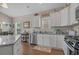 Kitchen featuring granite countertops, stainless steel appliances, white cabinets, and a breakfast area at 4319 Grande Harbour Blvd., Little River, SC 29566