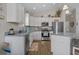 A well-lit kitchen with stainless steel appliances, white cabinets, and granite countertops offering a clean design at 4319 Grande Harbour Blvd., Little River, SC 29566