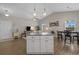 Open concept living area with vaulted ceiling, island, dining table, and access to other parts of the home at 4319 Grande Harbour Blvd., Little River, SC 29566