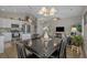Spacious layout featuring a dining table, living room, and kitchen with white cabinetry, ideal for hosting gatherings at 4319 Grande Harbour Blvd., Little River, SC 29566