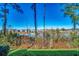 Lush backyard with scenic lake view and houses across the water offering a serene and private setting at 4486 Little River Inn Ln. # 2106, Little River, SC 29566
