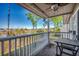 Covered balcony featuring a ceiling fan, outdoor furniture and scenic views of the lake and surrounding community at 4486 Little River Inn Ln. # 2106, Little River, SC 29566