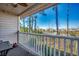 Balcony view showcasing the white railings, an outdoor table and chairs, and a serene water view beyond at 4486 Little River Inn Ln. # 2106, Little River, SC 29566