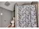 Cozy bathroom features a shower with a stylish blue and white floral shower curtain at 4486 Little River Inn Ln. # 2106, Little River, SC 29566