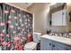 The bathroom features a floral shower curtain, toilet and a vanity with sink at 4486 Little River Inn Ln. # 2106, Little River, SC 29566