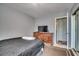 This bedroom is equipped with a traditional wooden dresser and a TV for entertainment at 4486 Little River Inn Ln. # 2106, Little River, SC 29566