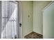 A cozy corner of an entryway featuring a door with a sheer curtain and neutral wall color at 4486 Little River Inn Ln. # 2106, Little River, SC 29566