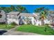 Inviting exterior of a two-story condo featuring lush landscaping and a well-maintained lawn at 4486 Little River Inn Ln. # 2106, Little River, SC 29566