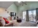 Cozy living room featuring a vaulted ceiling, plush sofa, and sliding doors to a private balcony at 4486 Little River Inn Ln. # 2106, Little River, SC 29566