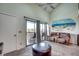 A cozy living room with a vaulted ceiling, featuring a sliding door to a private balcony at 4486 Little River Inn Ln. # 2106, Little River, SC 29566