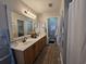 Bathroom featuring a double sink vanity with decorative mirror and fixtures at 45 Woodhaven Dr. # D, Murrells Inlet, SC 29576