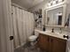 Cozy bathroom featuring wood vanity, patterned shower curtain and modern decor at 45 Woodhaven Dr. # D, Murrells Inlet, SC 29576