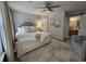 Spacious bedroom featuring a large bed, fan, windows, hardwood floors and light neutral wall paint at 45 Woodhaven Dr. # D, Murrells Inlet, SC 29576