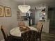 Elegant dining area with stylish chandelier, seamlessly connected to the modern kitchen at 45 Woodhaven Dr. # D, Murrells Inlet, SC 29576