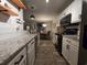 Well-appointed kitchen with stainless appliances and bar seating, open to the dining area at 45 Woodhaven Dr. # D, Murrells Inlet, SC 29576
