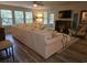 Cozy living room with a plush sectional sofa, ceiling fan, and ample natural light at 45 Woodhaven Dr. # D, Murrells Inlet, SC 29576