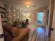 Bright home office with palm leaf wallpaper, desk, chair, and access to the outdoors from the glass paned door at 45 Woodhaven Dr. # D, Murrells Inlet, SC 29576