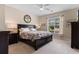 This bedroom features a dark wood bed frame, nightstands, and dressers and has lots of natural light at 4826 Keel Ct., Myrtle Beach, SC 29579