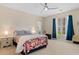 Bright bedroom with colorful bedding, a ceiling fan, and large windows at 4826 Keel Ct., Myrtle Beach, SC 29579