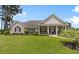 Charming brick home features a well-manicured lawn and a welcoming covered porch at 4826 Keel Ct., Myrtle Beach, SC 29579