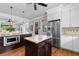 Charming kitchen with stainless steel refrigerator, large center island, and warm wood flooring at 4826 Keel Ct., Myrtle Beach, SC 29579