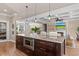 Kitchen island with granite countertops, microwave, and seamless view into the connected living room at 4826 Keel Ct., Myrtle Beach, SC 29579