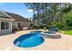Backyard pool and jacuzzi with lush landscaping and patio area at 4826 Keel Ct., Myrtle Beach, SC 29579