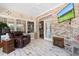Relaxing sunroom featuring a brick accent wall and a view to the main house at 4826 Keel Ct., Myrtle Beach, SC 29579