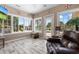 Bright sunroom featuring hardwood floors, a ceiling fan, and a view of the pool at 4826 Keel Ct., Myrtle Beach, SC 29579