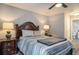 Comfortable bedroom featuring two matching bedside tables with lamps and a view of the en-suite bathroom at 4853 Meadowsweet Dr. # 1805, Myrtle Beach, SC 29579