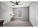 Cozy bedroom with neutral carpet, a ceiling fan, and a window offering natural light and neighborhood views at 4853 Meadowsweet Dr. # 1805, Myrtle Beach, SC 29579