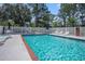 Inviting community pool area with clear blue water, lounge chairs, and a well-maintained surrounding area at 4853 Meadowsweet Dr. # 1805, Myrtle Beach, SC 29579