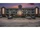 Condo building with balconies and parking in front showing dusk sky with peach and purple colors at 4853 Meadowsweet Dr. # 1805, Myrtle Beach, SC 29579