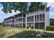 Back exterior view showcasing the building with screened porches and backyard at 4853 Meadowsweet Dr. # 1805, Myrtle Beach, SC 29579