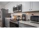 Kitchen area with white subway tile back splash, granite countertops, stainless appliances, and gray cabinets at 4853 Meadowsweet Dr. # 1805, Myrtle Beach, SC 29579