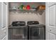 Laundry room with a shelf and modern black Samsung washer and dryer units for convenient laundry care at 4853 Meadowsweet Dr. # 1805, Myrtle Beach, SC 29579