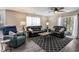 Living room area with leather sofas, ceiling fan, accent rug, and a sliding door to the outside at 4853 Meadowsweet Dr. # 1805, Myrtle Beach, SC 29579