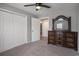 Carpeted main bedroom featuring a ceiling fan, a dresser with mirror, and closet spaces for ample storage at 4853 Meadowsweet Dr. # 1805, Myrtle Beach, SC 29579