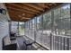 Relaxing screened porch featuring a wooden ceiling, ceiling fan, wicker furniture, and views of neighborhood at 4853 Meadowsweet Dr. # 1805, Myrtle Beach, SC 29579